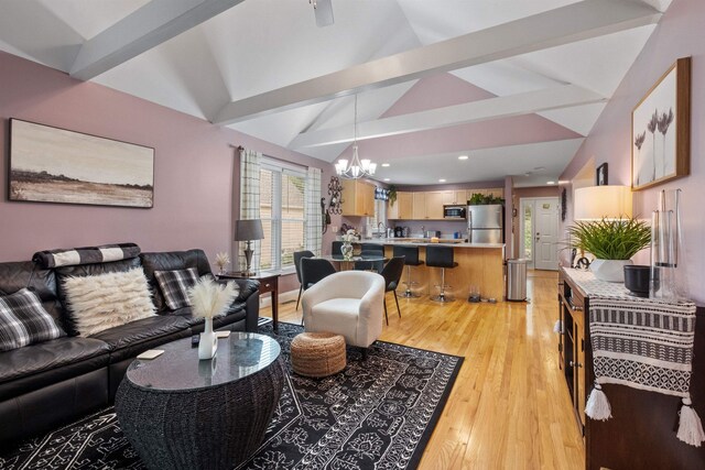 living room with light hardwood / wood-style floors, lofted ceiling with beams, and a notable chandelier