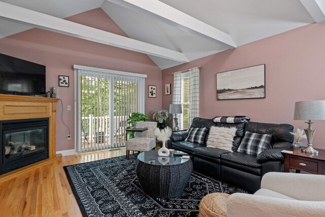 living room featuring lofted ceiling and hardwood / wood-style flooring