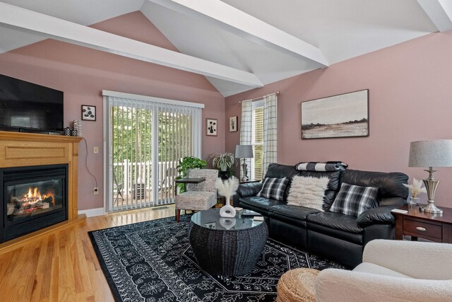 living room with vaulted ceiling and hardwood / wood-style flooring