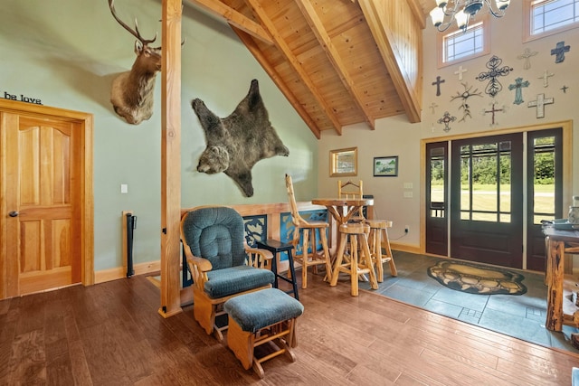 foyer entrance with wood-type flooring, high vaulted ceiling, wooden ceiling, a notable chandelier, and beam ceiling