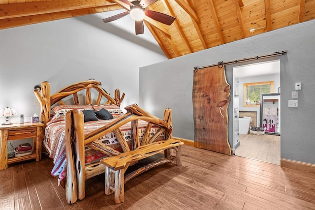 bedroom featuring beamed ceiling, wood ceiling, a barn door, and hardwood / wood-style floors