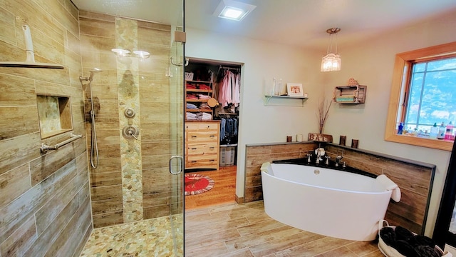 bathroom with plus walk in shower and hardwood / wood-style floors