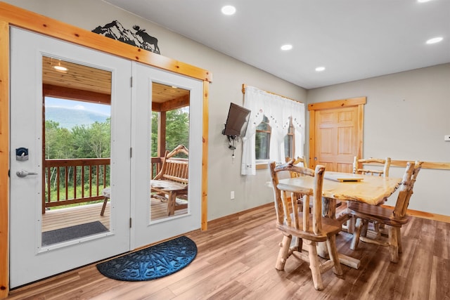 dining space featuring french doors and light hardwood / wood-style floors