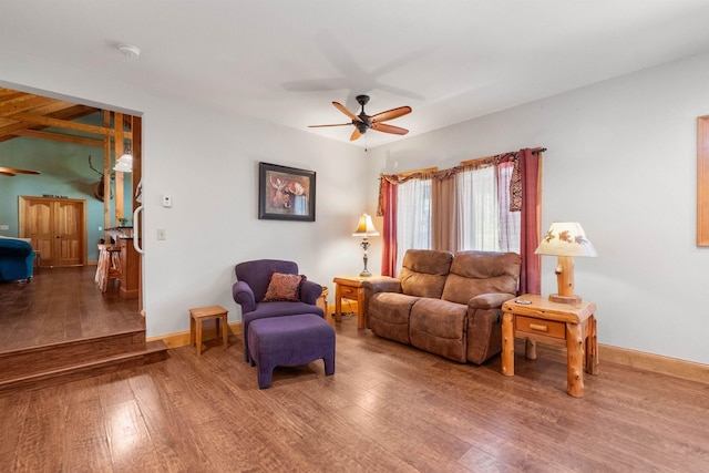 living room with wood-type flooring and ceiling fan