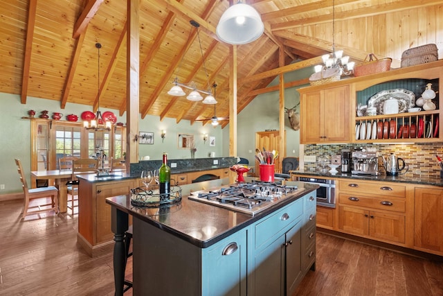 kitchen featuring pendant lighting, appliances with stainless steel finishes, a breakfast bar, and a kitchen island