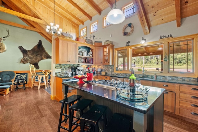 kitchen featuring tasteful backsplash, a breakfast bar area, wooden ceiling, and a kitchen island