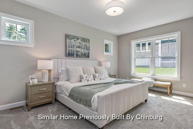 bedroom featuring light colored carpet