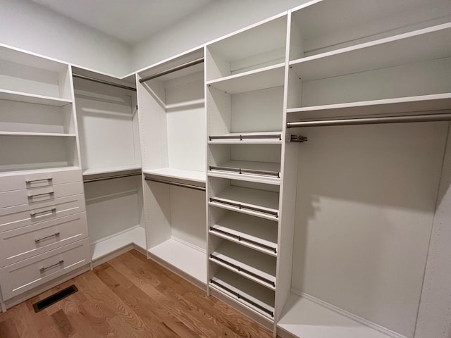 spacious closet featuring visible vents and wood finished floors