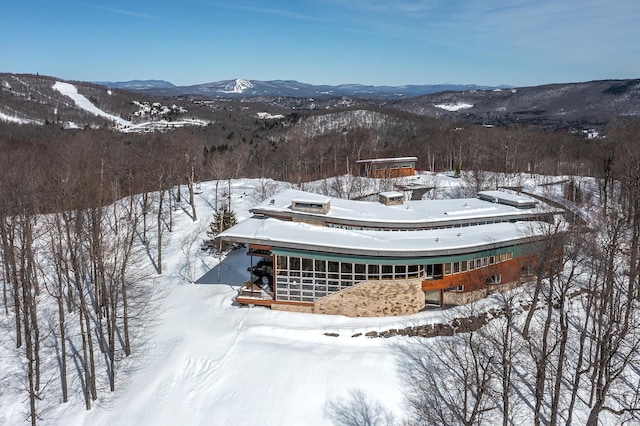 snowy aerial view with a mountain view