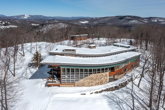 snowy aerial view with a mountain view