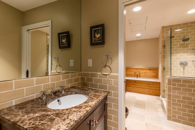 bathroom featuring tile walls, an enclosed shower, vanity, and tile patterned flooring