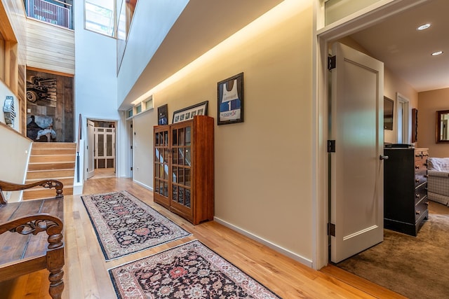 hallway with hardwood / wood-style floors