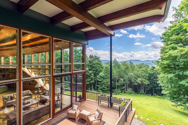 unfurnished sunroom with a mountain view