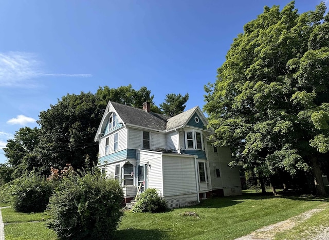 view of home's exterior with a lawn