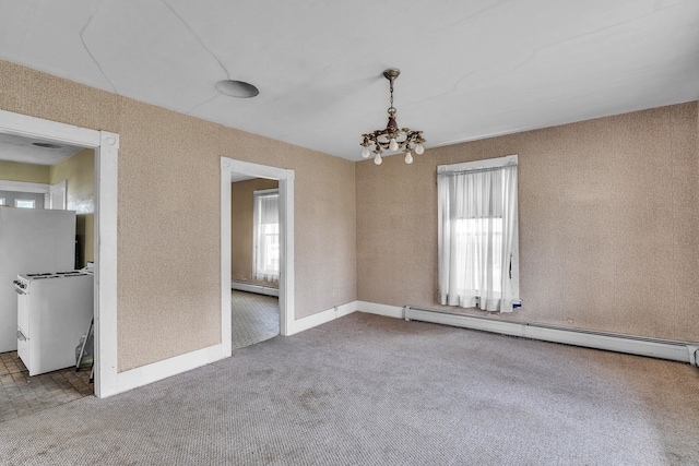 carpeted empty room with a baseboard heating unit and a chandelier