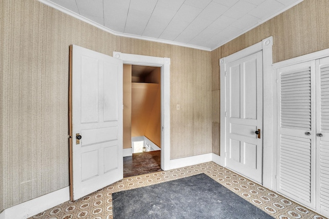 unfurnished bedroom featuring ornamental molding and a closet