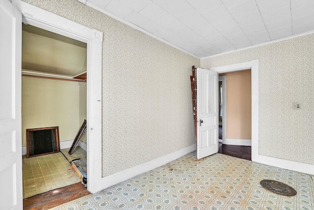 unfurnished bedroom featuring ornamental molding and a closet