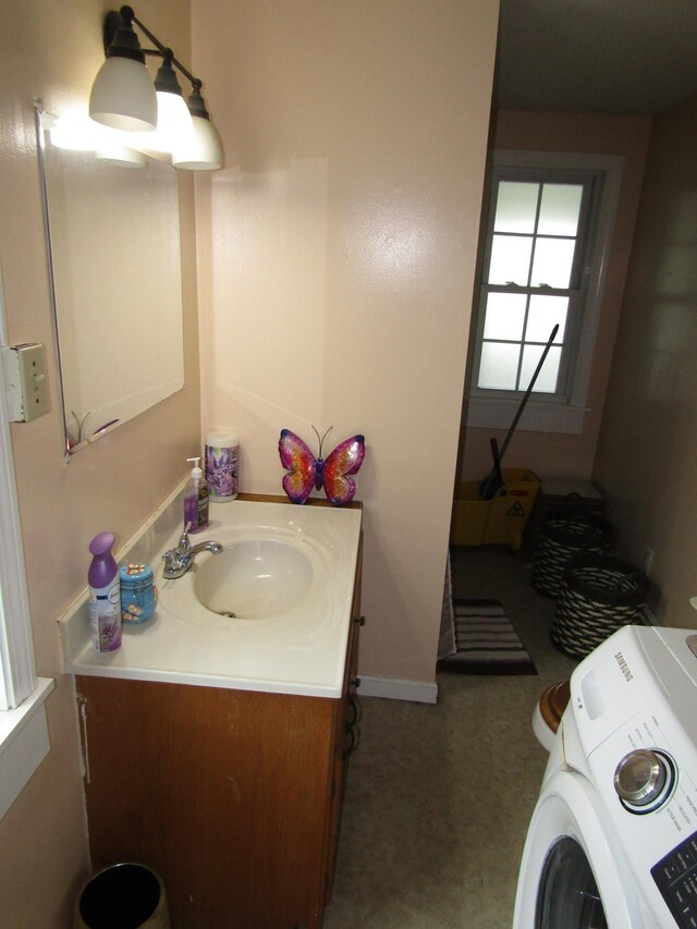 bathroom featuring vanity and washer / dryer