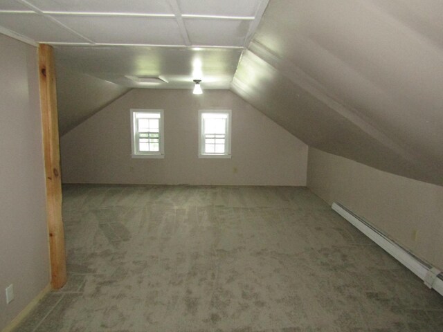 bonus room featuring carpet floors, a baseboard heating unit, and vaulted ceiling