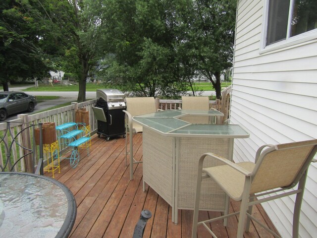 wooden terrace featuring a grill