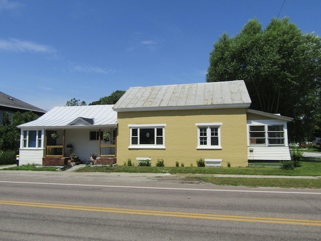 view of front of property with covered porch and a sunroom