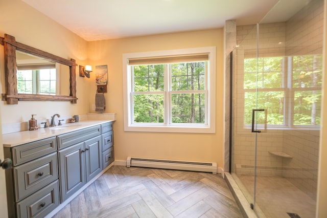 bathroom featuring walk in shower, parquet flooring, vanity, and a baseboard heating unit