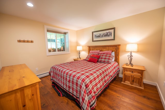 bedroom with a baseboard radiator and dark hardwood / wood-style flooring