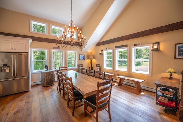 dining area with baseboard heating, high vaulted ceiling, and hardwood / wood-style floors