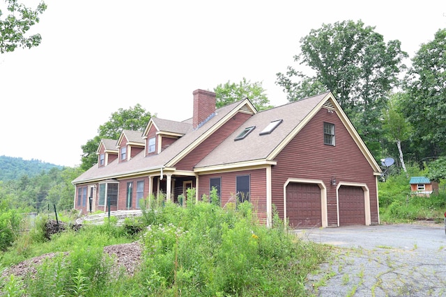 cape cod house with a garage