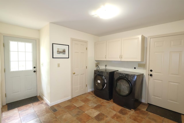 washroom with separate washer and dryer, cabinets, and light tile patterned flooring