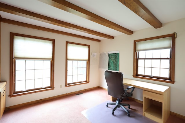 carpeted office with plenty of natural light and beamed ceiling