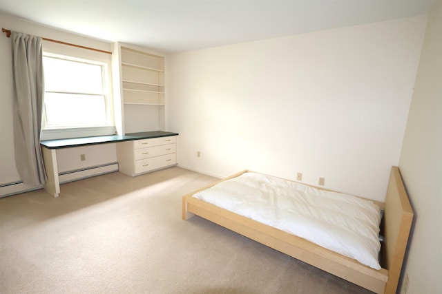 carpeted bedroom featuring baseboard heating