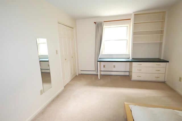 unfurnished office featuring a baseboard radiator and light carpet