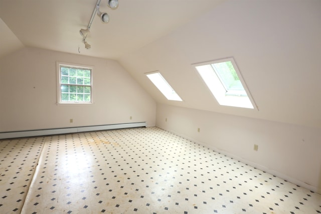 bonus room featuring a baseboard radiator, vaulted ceiling with skylight, and carpet flooring