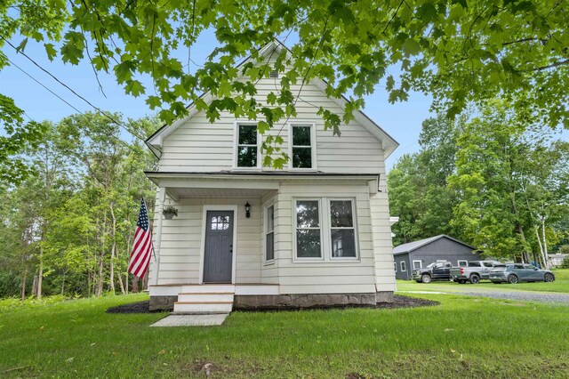 bungalow-style house with a front lawn