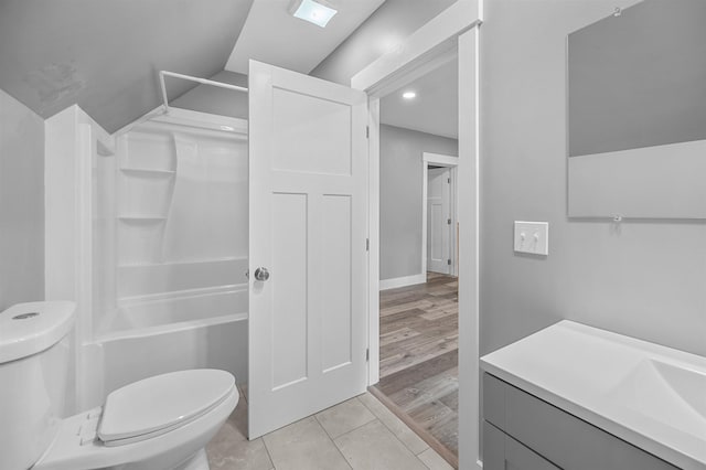 bathroom featuring lofted ceiling, toilet, and wood-type flooring