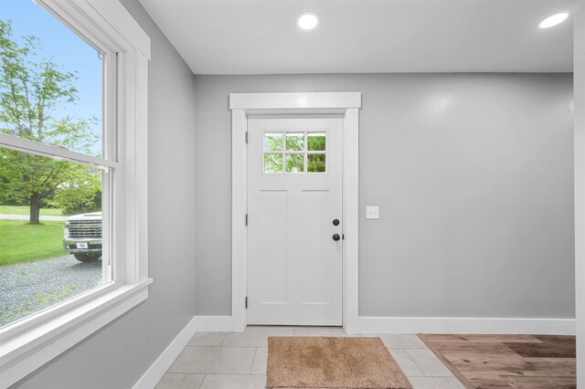 doorway with light tile patterned flooring