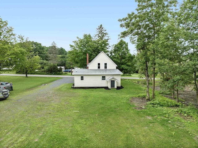 view of side of property with a yard