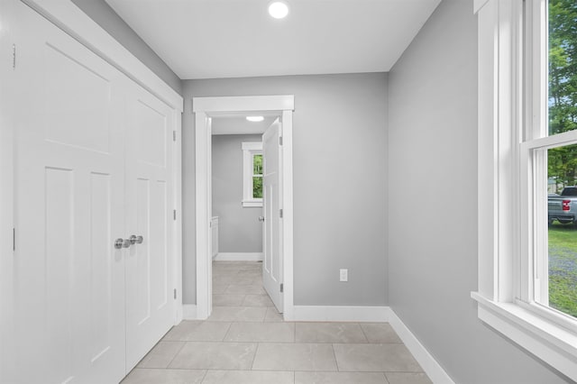 hallway featuring light tile patterned floors