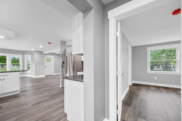 hall with hardwood / wood-style flooring and plenty of natural light