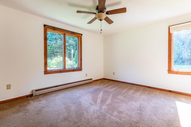 full bathroom featuring a wealth of natural light, vanity, toilet, and a baseboard radiator