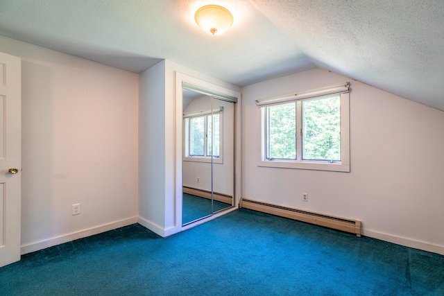 bonus room featuring a baseboard radiator, vaulted ceiling, and a textured ceiling