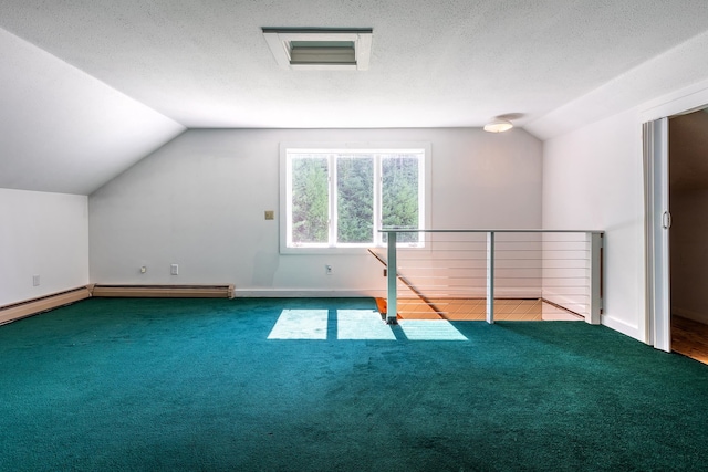 additional living space with carpet floors, vaulted ceiling, a baseboard radiator, and a textured ceiling