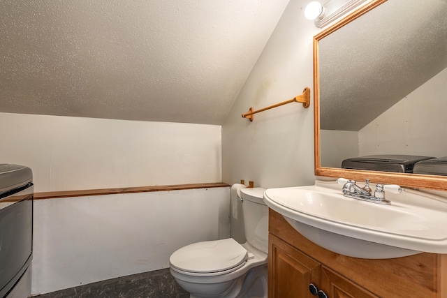 bathroom with toilet, vaulted ceiling, and vanity