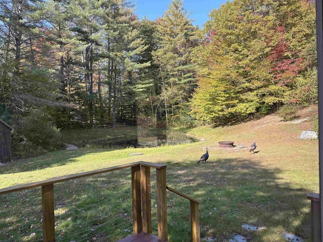 view of yard featuring an outdoor fire pit