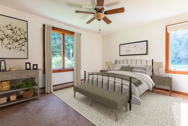 bedroom with ceiling fan, carpet, and a baseboard heating unit