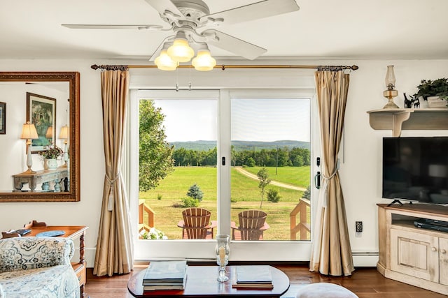 interior space featuring ceiling fan, dark hardwood / wood-style flooring, and a baseboard radiator