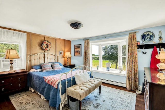 bedroom featuring a baseboard radiator and dark hardwood / wood-style floors