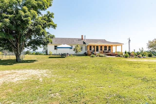 single story home with a gazebo, covered porch, and a front lawn