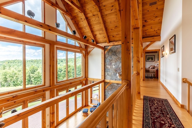 unfurnished sunroom featuring wood ceiling and lofted ceiling with beams